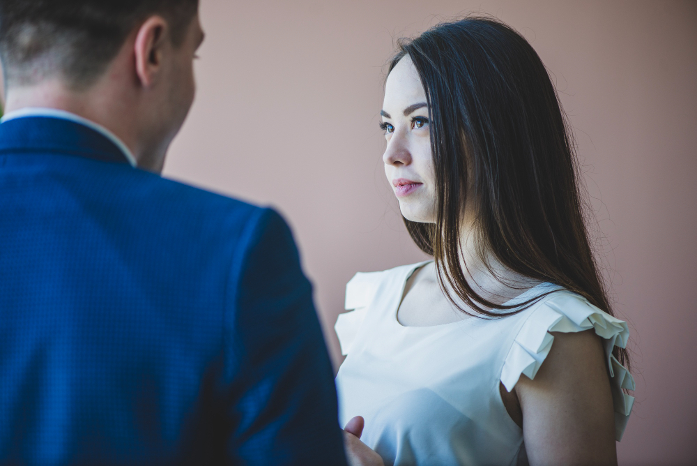 Boy with blue coat and girl with white top looking each others before marriage.